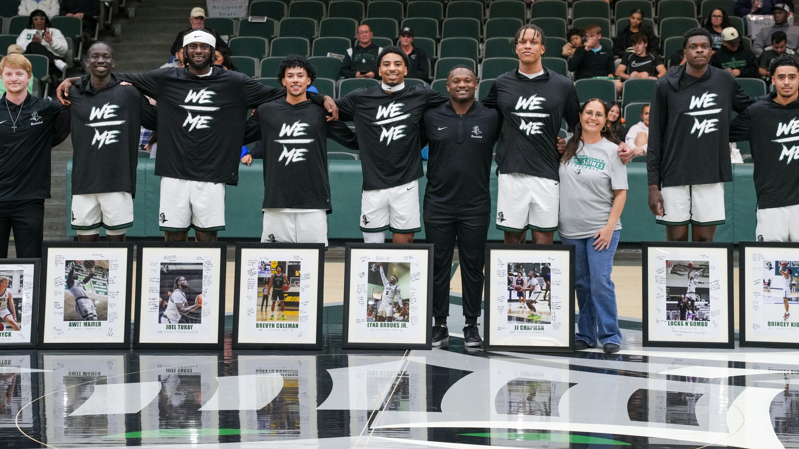 The Seward men's basketball sophomores as well as head coach Austin Downing pose for a photo.